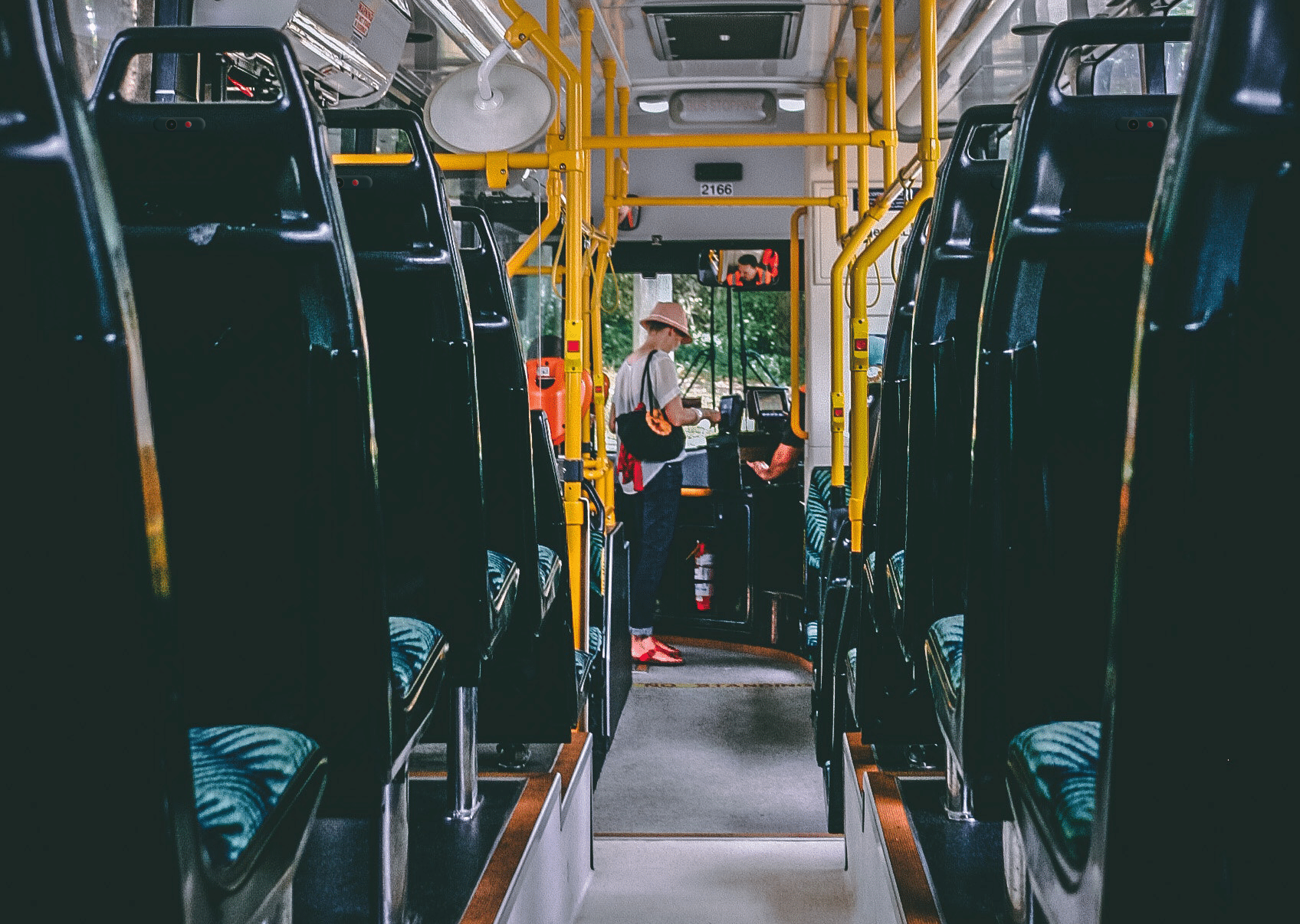 backs of bus seats each with a camera fitted