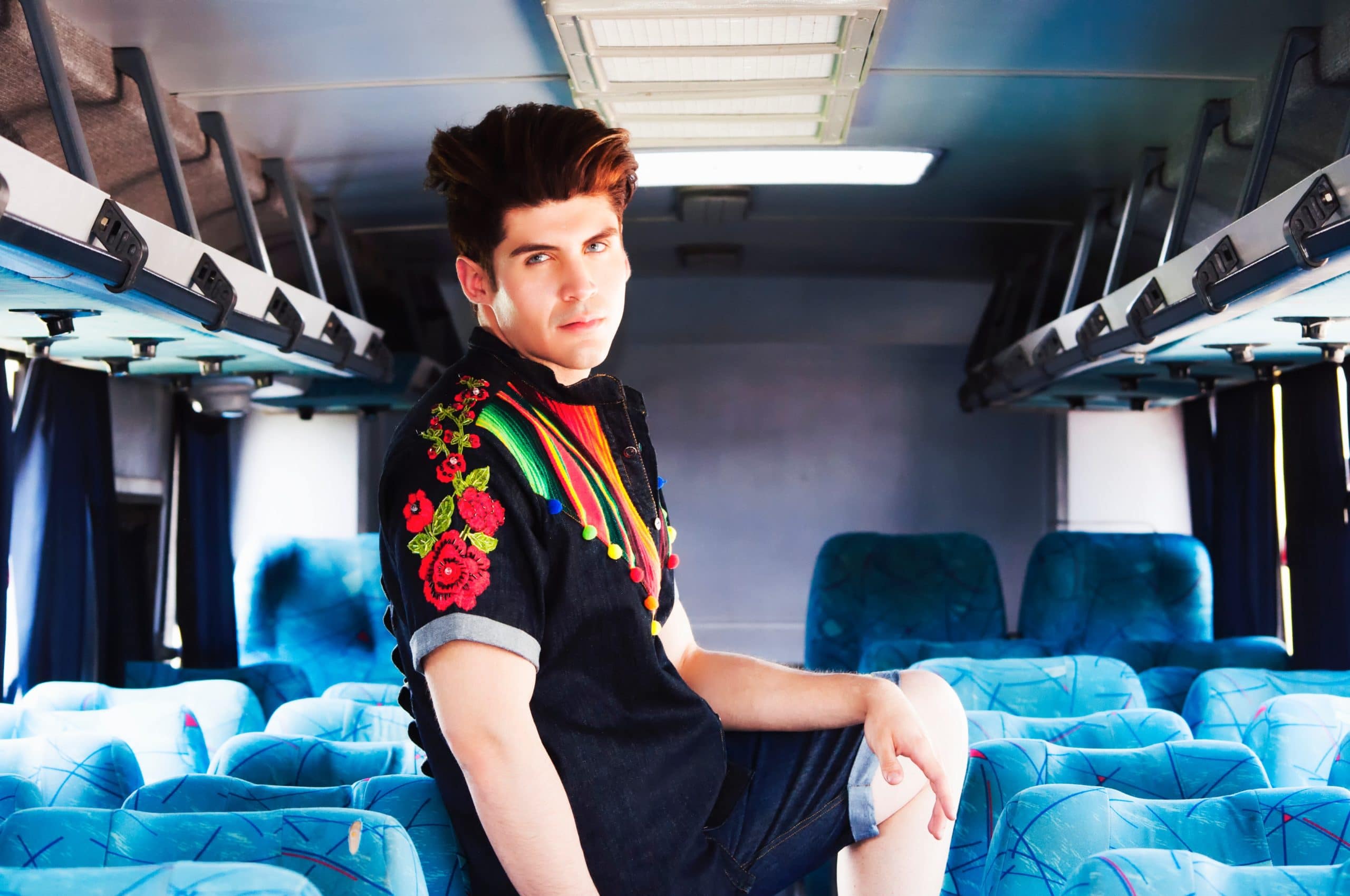 man posing in the middle of a bus