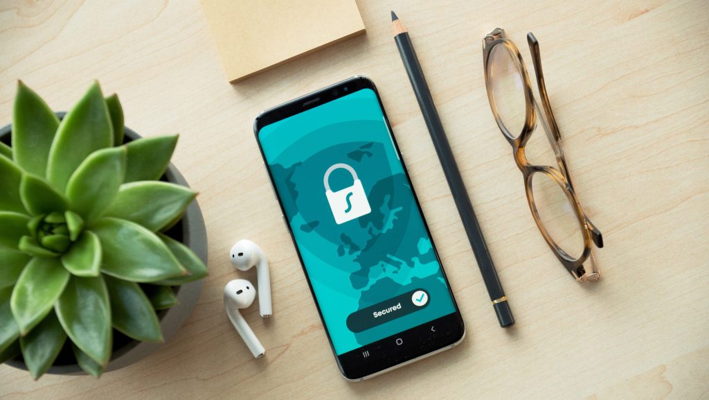 Phone on a desk showing a lock screen