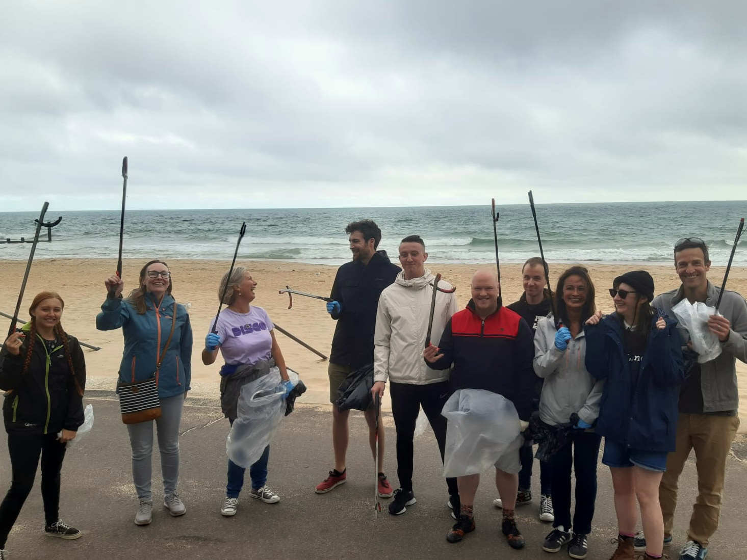 Passenger staff on the beach cheering.