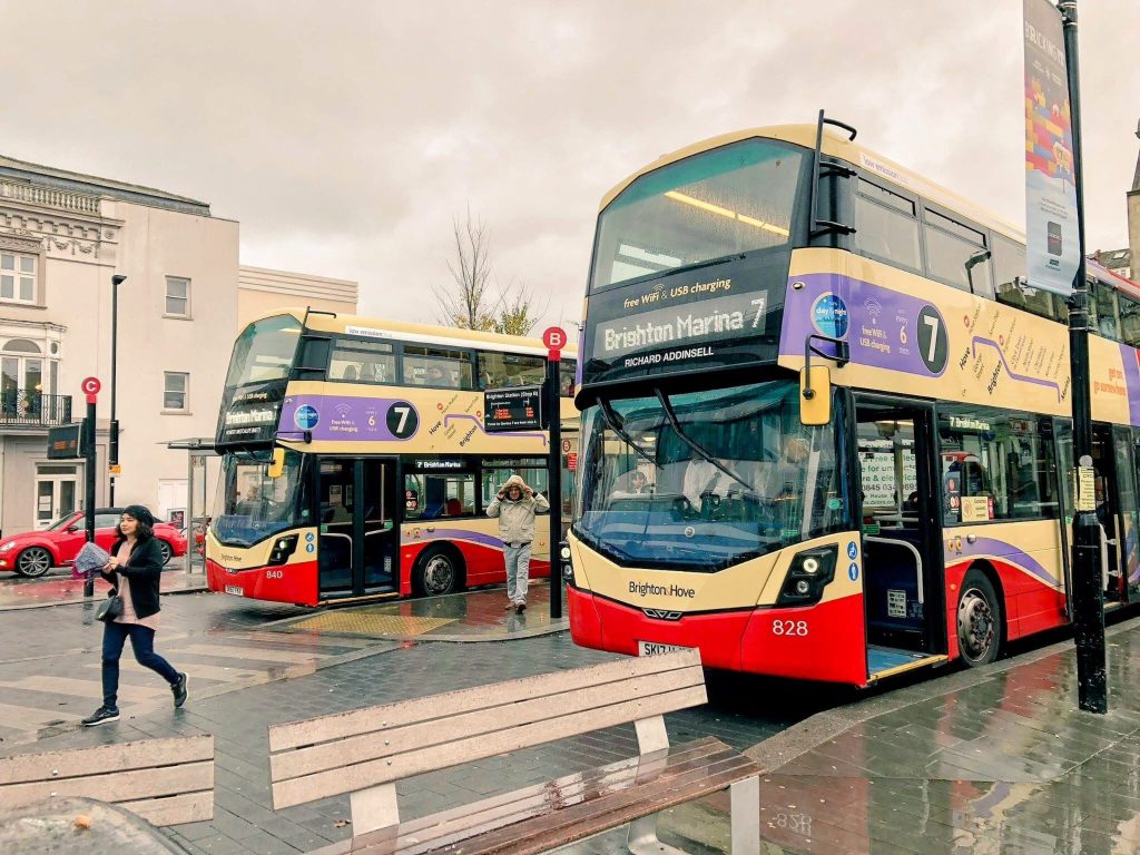 Two double decker Brighton & Hove Buses outside Brighton railway station